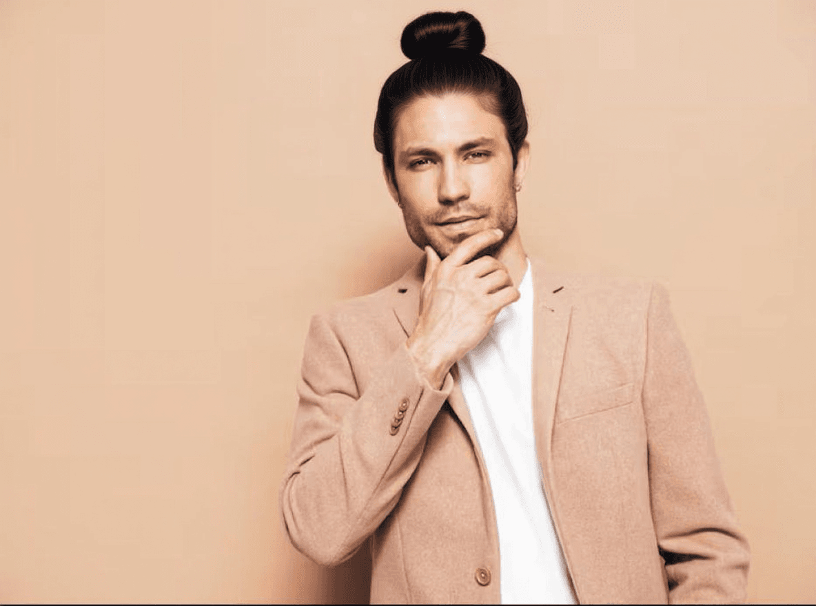 Man bun example: long hair pulled back into a compact bun at the crown